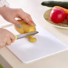 Cutting board made of plastic, perfect for chopping and slicing.